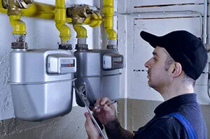 Gas technician examining a meter